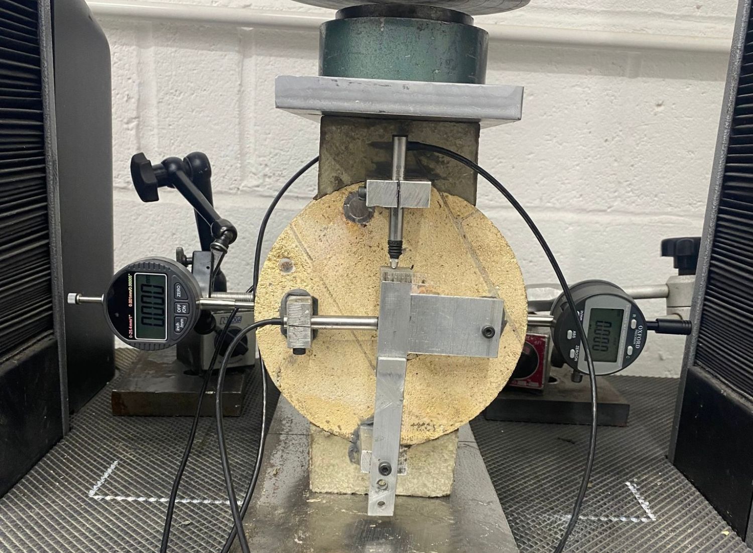 Concrete sample tested for compressive strength using calibrated press